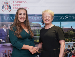 award winner shaking hand and smiling